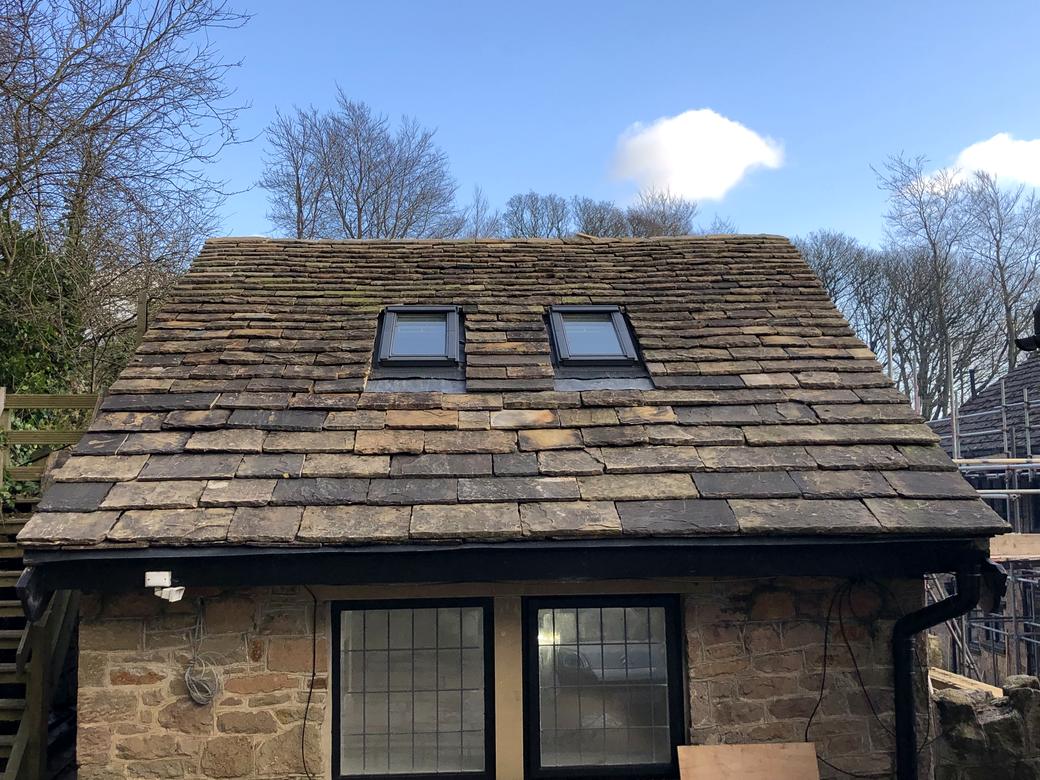 Reclaimed stone slate re-roof on a Peak District barn with two rooflights